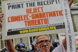 Activists hold a picket on Tuesday outside the Commission on Elections (Comelec) criticizing its apprehension in printing voter receipts. The Supreme Court recently issued a resolution mandating Comelec to activate the "voter-verified paper audit trail" to allow confirmation of votes.(MNS photo)