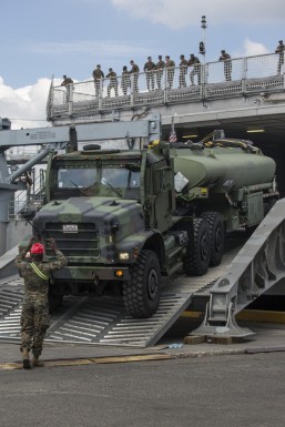 SUBIC BAY, Philippines (March 30, 2016) A U.S. Marine with 4th Combat Logistics Battalion navigates a Medium Tactical Vehicle Replacement using hand signals during Balikatan 2016 (BK 16) in Subic Bay, Philippines on March 30, 2016. The purpose of BK 16 is to strengthen interoperability and partner-nation capabilities for the planning and execution of military operations, and advance regional security operations. (U.S. photo by Lance Cpl. Damon A. Mclean/Released)